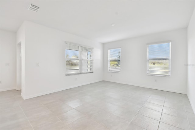 spare room with light tile patterned floors