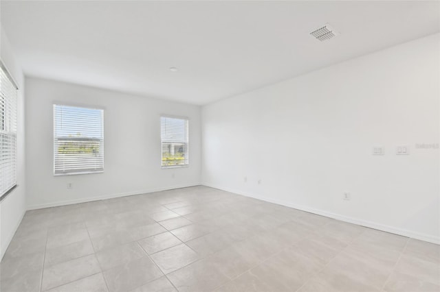 spare room featuring light tile patterned floors