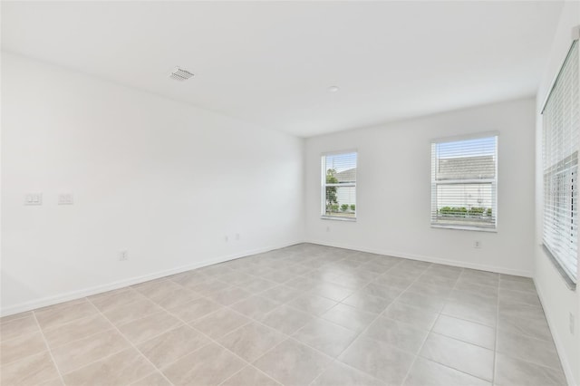 spare room featuring light tile patterned floors