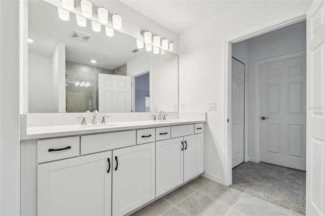 bathroom featuring vanity, tile patterned flooring, and a shower with door