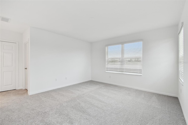 unfurnished room with light colored carpet