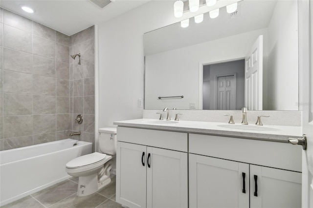 full bathroom featuring toilet, tile patterned flooring, tiled shower / bath combo, and vanity