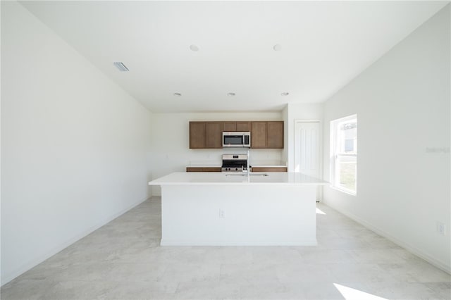 2203 Carson Loop, Lake Wales, FL 33859 - kitchen with stainless steel appliances, light countertops, visible vents, a sink, and a center island with sink