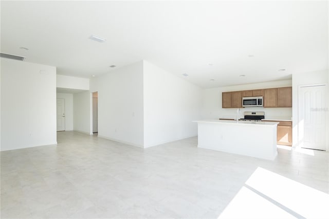 2203 Carson Loop, Lake Wales, FL 33859 - unfurnished living room featuring visible vents, a sink, and light floors