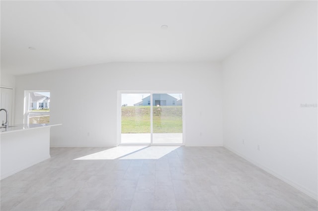 2203 Carson Loop, Lake Wales, FL 33859 - unfurnished living room with plenty of natural light, vaulted ceiling, and a sink