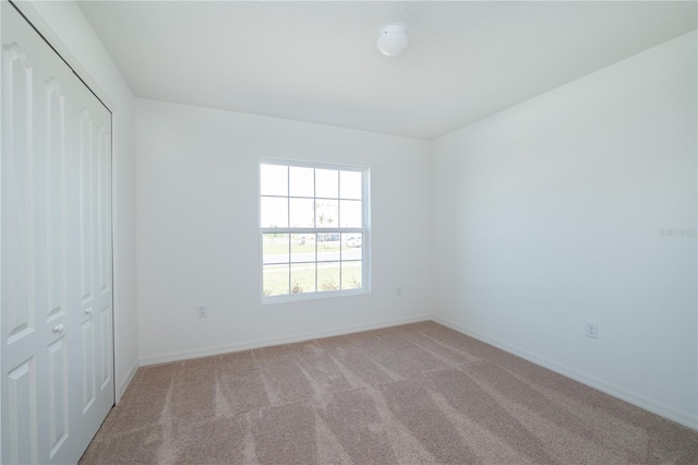 2203 Carson Loop, Lake Wales, FL 33859 - unfurnished bedroom with carpet, baseboards, and a closet