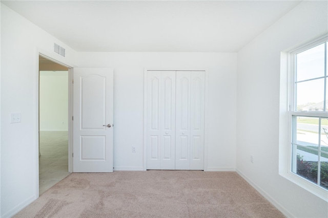 2203 Carson Loop, Lake Wales, FL 33859 - unfurnished bedroom featuring baseboards, visible vents, carpet floors, and a closet