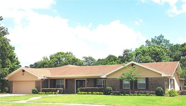 ranch-style home with a garage and a front lawn