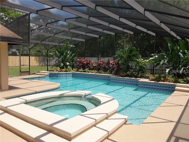 view of swimming pool with a lanai and an in ground hot tub