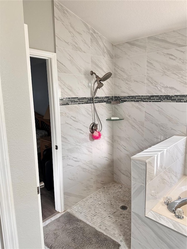 bathroom with a tile shower