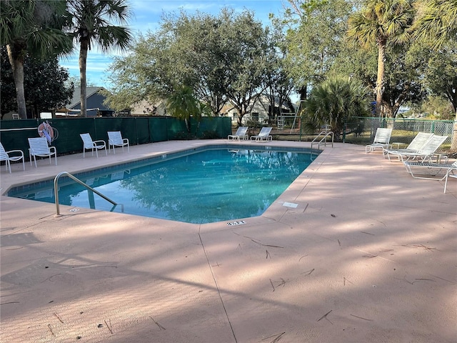 view of swimming pool with a patio