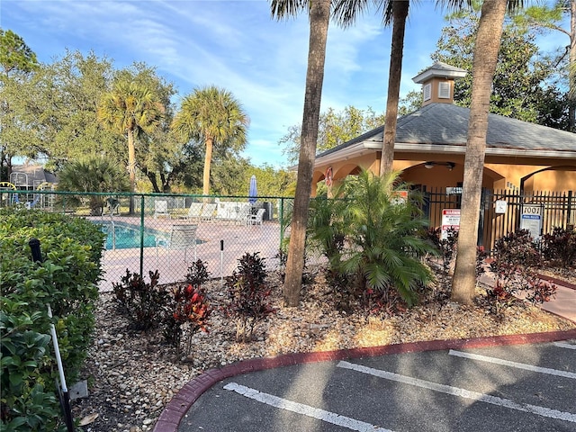 view of pool featuring ceiling fan