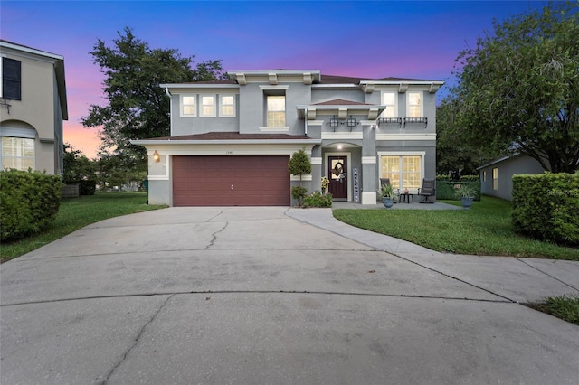 view of front of home with a garage and a yard