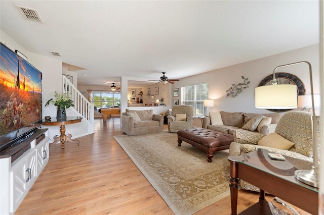 living room with ceiling fan and light wood-type flooring