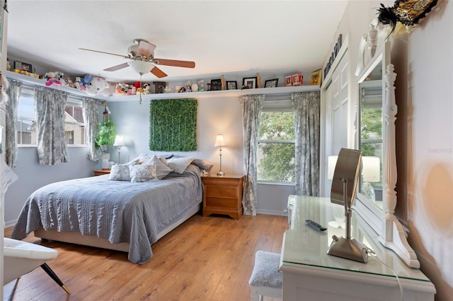 bedroom with ceiling fan and light wood-type flooring