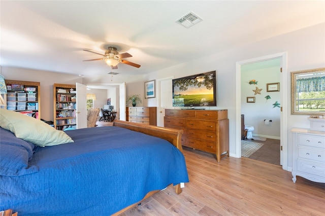 bedroom featuring ceiling fan, light wood-type flooring, and ensuite bath