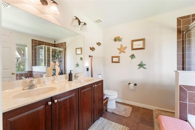 bathroom featuring vanity, toilet, and a shower with shower door