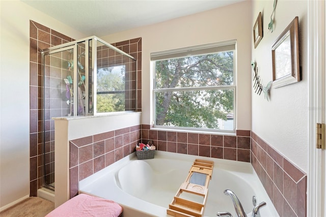 bathroom featuring separate shower and tub