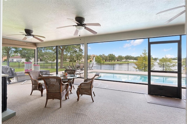 sunroom / solarium featuring ceiling fan