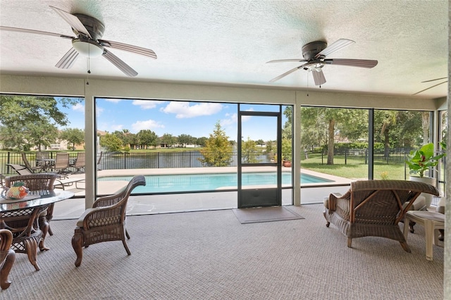 sunroom / solarium with ceiling fan and a healthy amount of sunlight