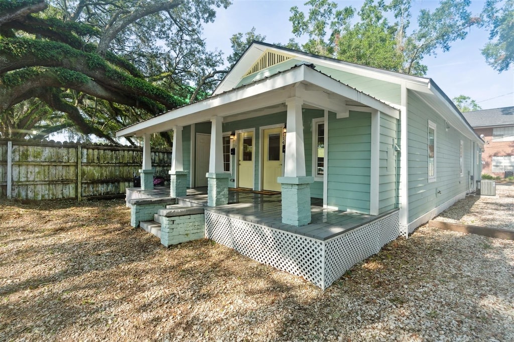 view of property exterior featuring central AC unit and a porch