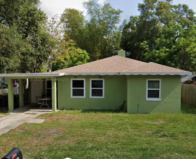 view of front of house featuring a front lawn and a carport