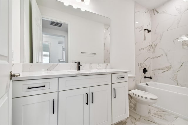 full bathroom with vanity, tiled shower / bath combo, and toilet