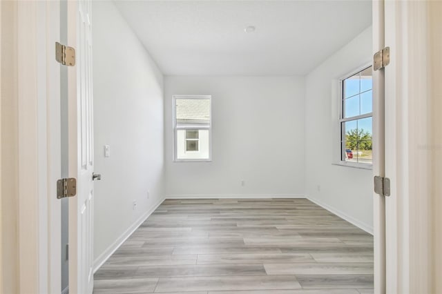 empty room featuring light hardwood / wood-style flooring and a healthy amount of sunlight