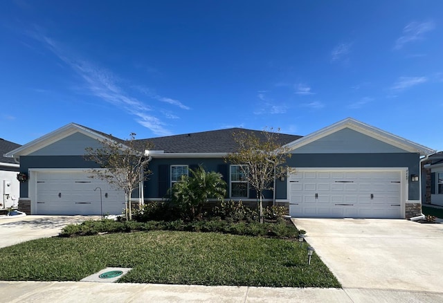 single story home with a garage and a front yard