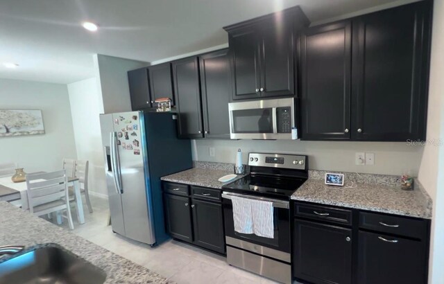 kitchen featuring light stone countertops and appliances with stainless steel finishes