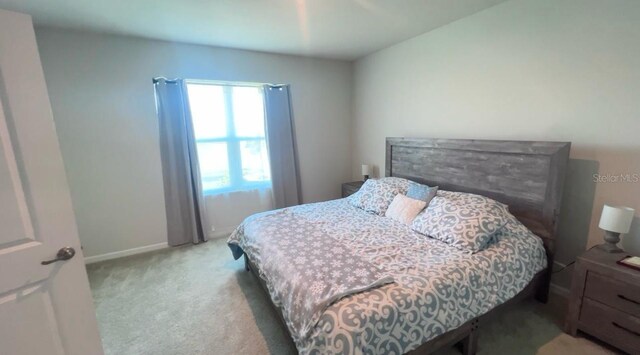 bedroom featuring light carpet