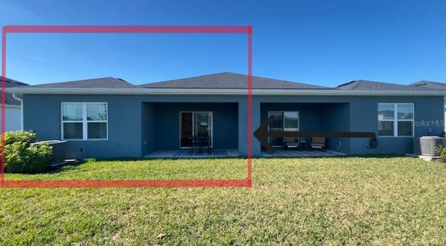 back of property with a lawn, a patio area, and central air condition unit