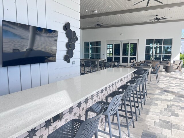 view of patio / terrace featuring an outdoor bar and ceiling fan