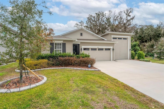 view of front of house featuring a garage and a front lawn