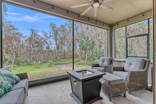 sunroom / solarium featuring ceiling fan and plenty of natural light