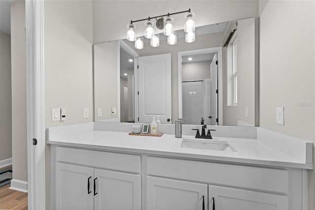 bathroom with hardwood / wood-style floors, a shower with curtain, and vanity