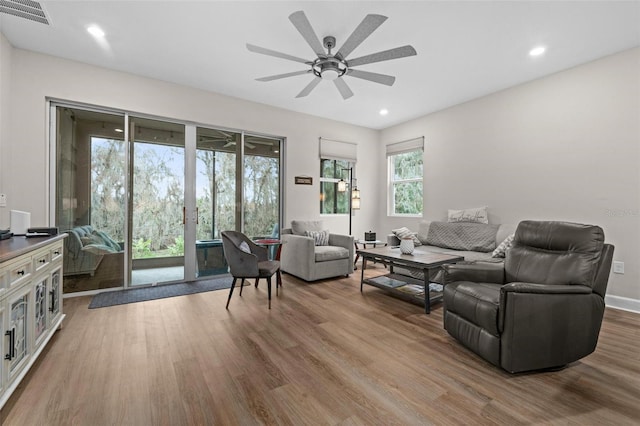 living room with ceiling fan and wood-type flooring