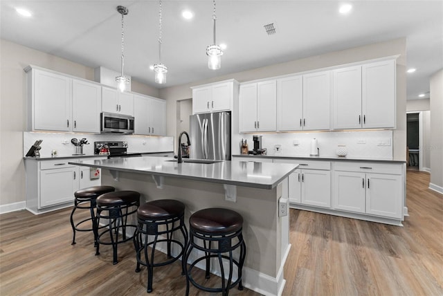 kitchen with white cabinetry and stainless steel appliances