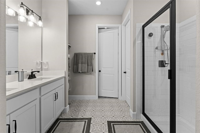 bathroom featuring tile patterned flooring, vanity, and a shower with door