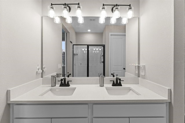 bathroom featuring vanity and an enclosed shower