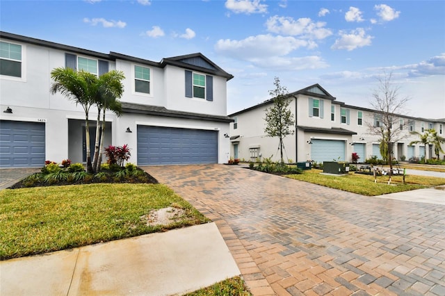 view of front of property with a garage and a front yard