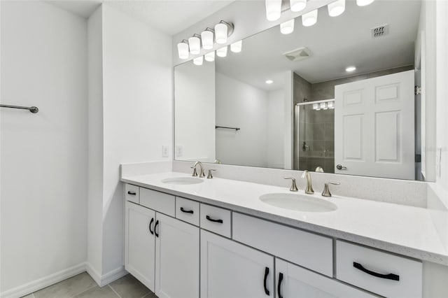 bathroom with vanity, tile patterned flooring, and a shower with door