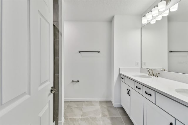 bathroom featuring vanity, tile patterned flooring, and a textured ceiling