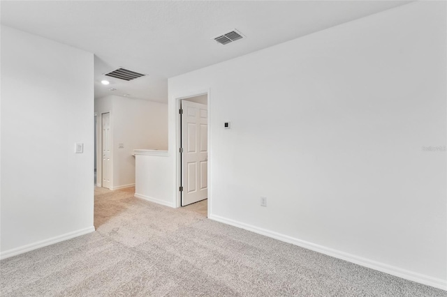 unfurnished room featuring light carpet