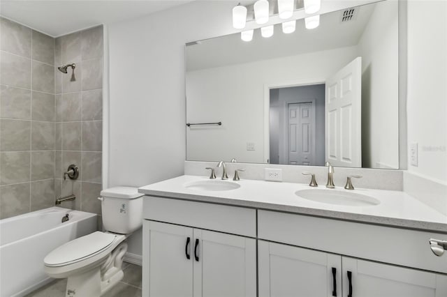 full bathroom featuring vanity, toilet, and tiled shower / bath