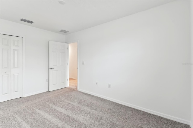 unfurnished bedroom with a closet and carpet