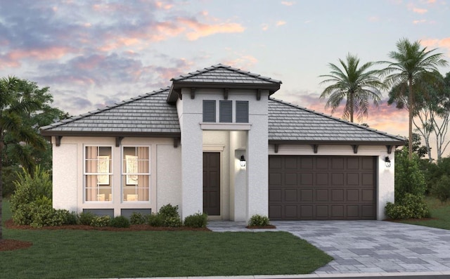 view of front of home with a yard and a garage