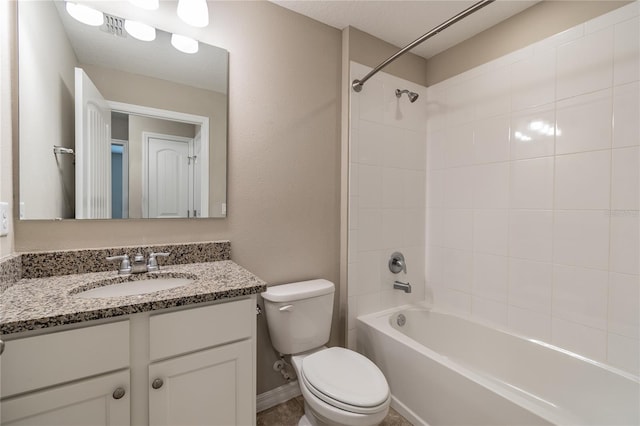 full bathroom with vanity, tiled shower / bath combo, and toilet