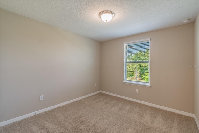 unfurnished room featuring a textured ceiling and carpet floors