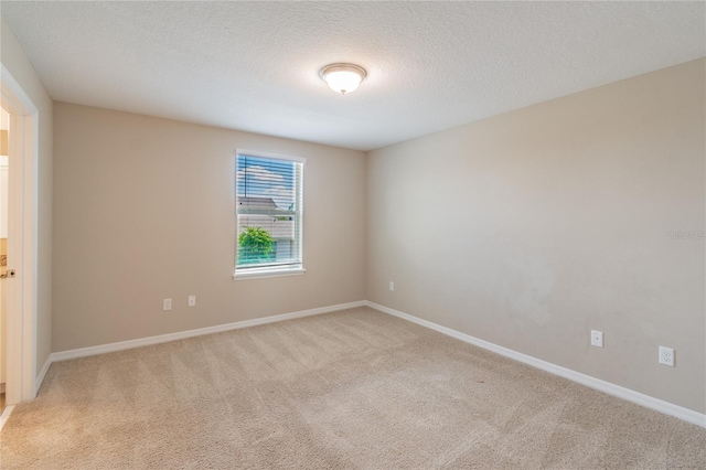 carpeted spare room with a textured ceiling